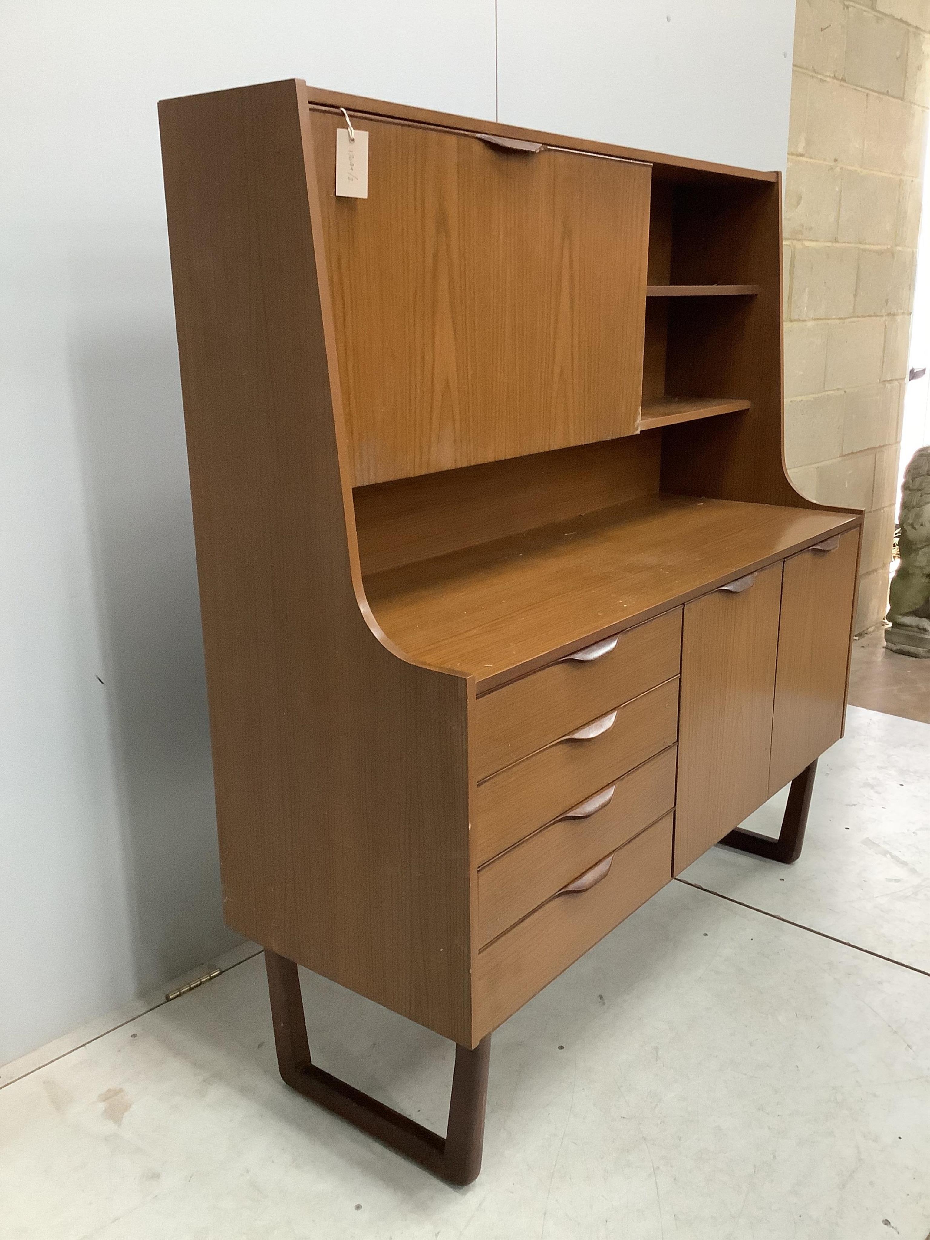 A mid century 'Europa Furniture' simulated teak sideboard, width 125cm, depth 46cm, height 138cm. Condition - fair